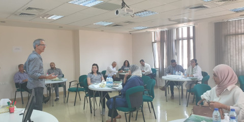 Director of CCE opening the discussion with people sitting and listening