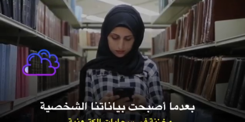 Young woman in a library with her mobile phone